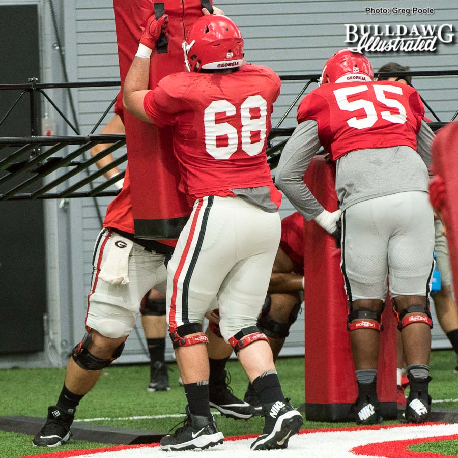 Sean Fogarty (68) and Dyson Sims (55) work under the chute during Wednesday's practice