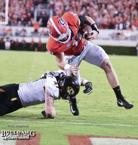 Jake Fromm (11) avoids the tackle to punch it in the end zone during Georgia's homecoming game versus Missouri