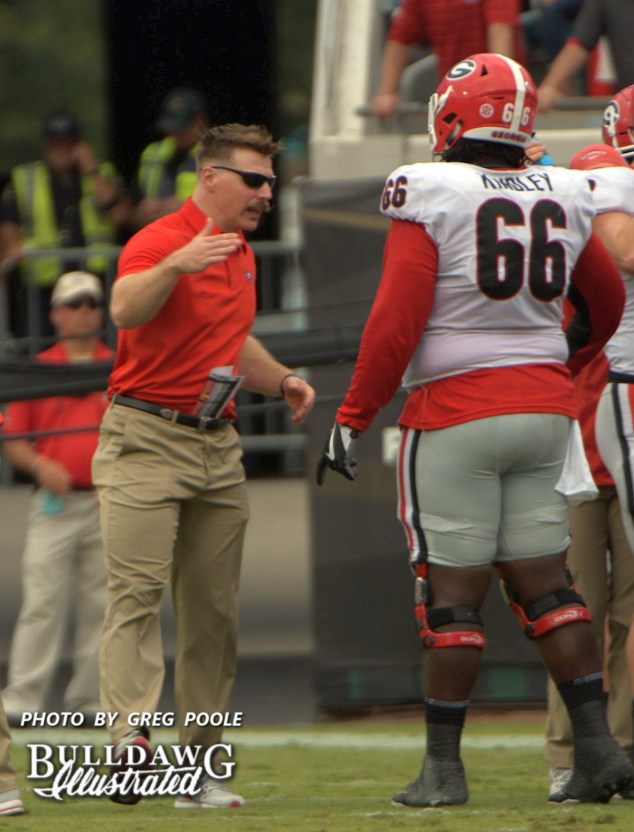 Georgia's assistant strength and conditioning coach, Aaron Fields, is there to give Solomon Kindley (66) a "that a boy." - Georgia-Florida, Saturday, Oct. 28, 2017 -