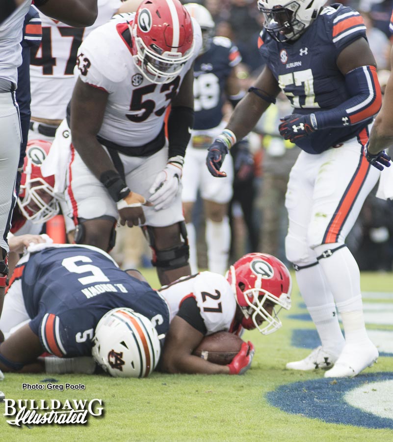 Nick Chubb (27) punches the ball across the goal line to give Georgia a touchdown in the first quarter. - UGA vs. Auburn, Sat., Nov. 11, 2017 -