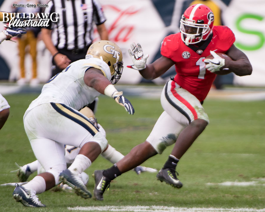 Sony Michel (1) leaves a Jacket eating turf and is about to give another one the 'heave-ho' with a stiff arm. - UGA vs. GT - Saturday, Nov. 25, 2017 -