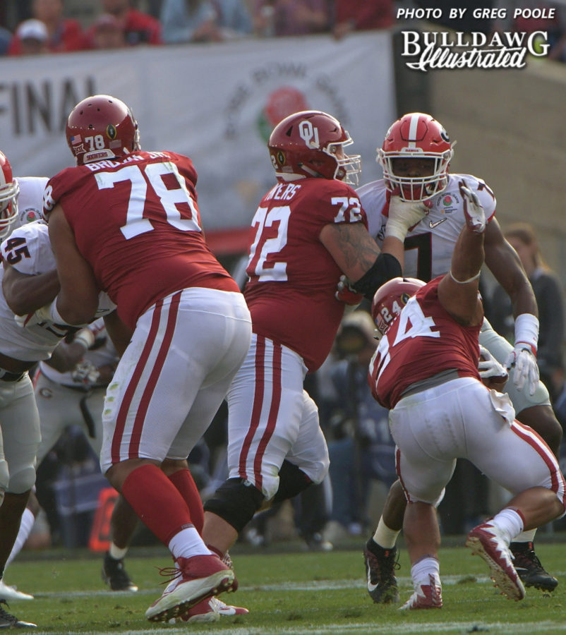 Sooner offensive lineman (72) helps UGA OLB Lorenzo Carter (7) adjust his mouth piece and chin strap. - Rose Bowl, 2nd quarter, Monday, Jan. 1, 2018 -