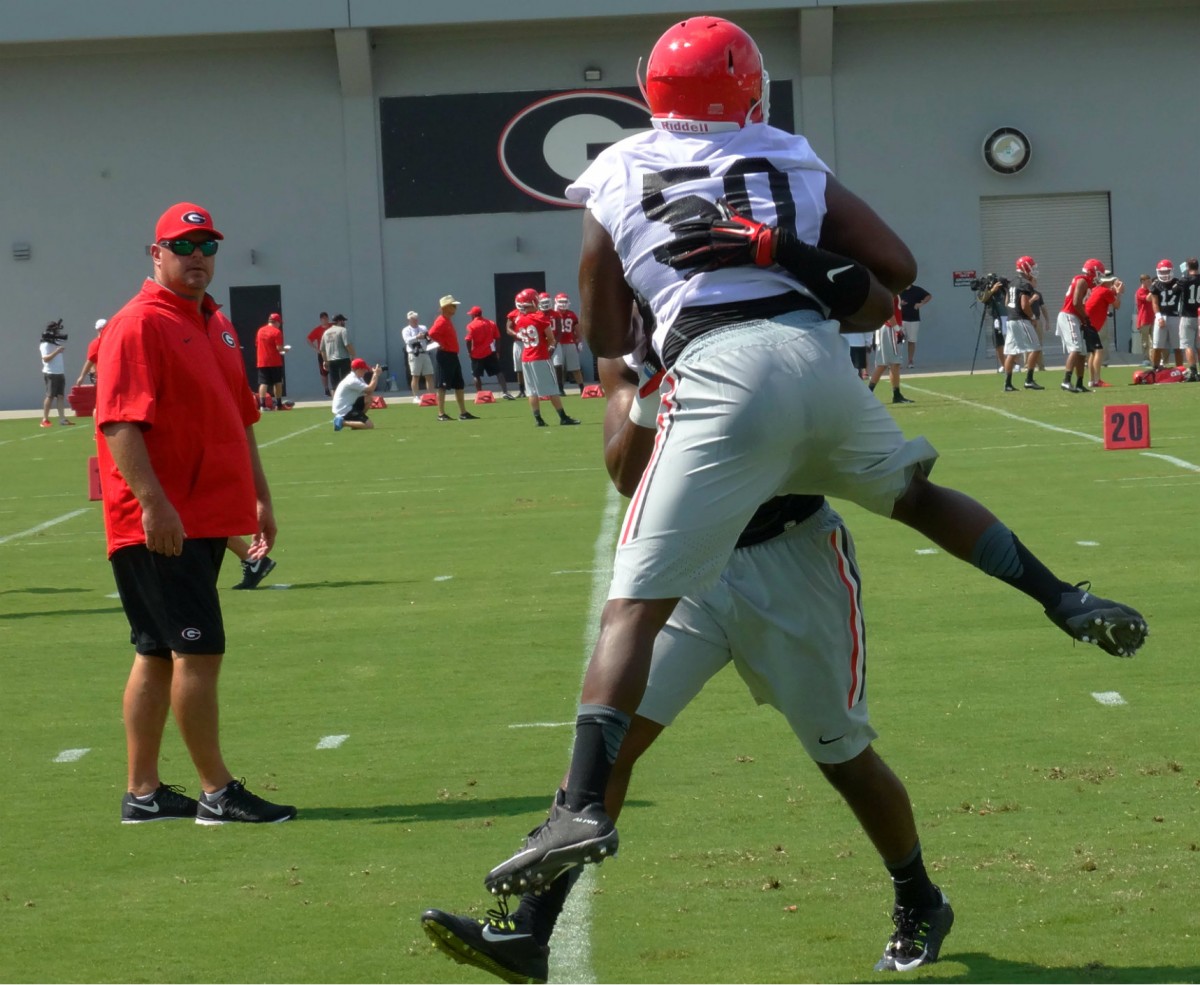 Johnny O'Neal gets tackled in drill as coach Shearer looks on