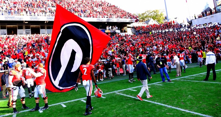 Davin Bellamy (17) and Leonard Floyd (84) plant the flag