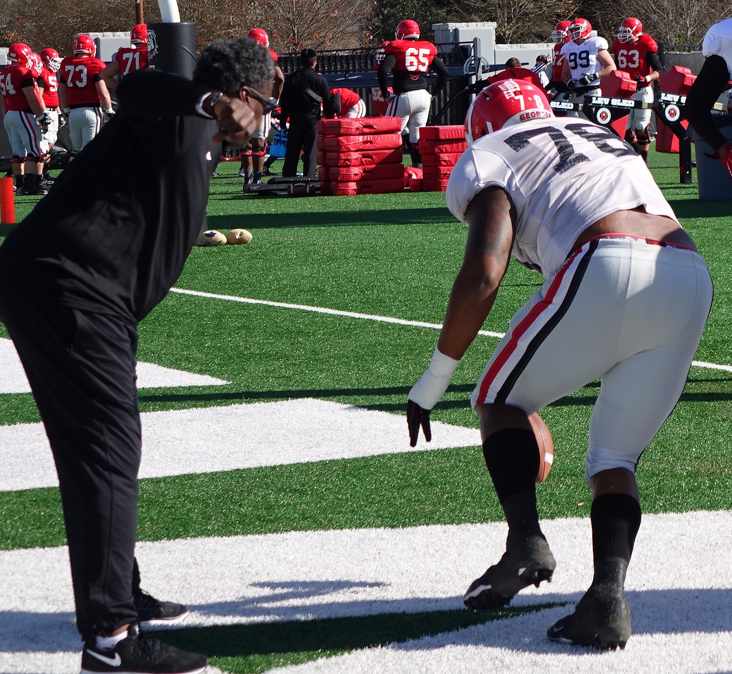 Coach Rocker encourages Trent Thompson during fumble drill