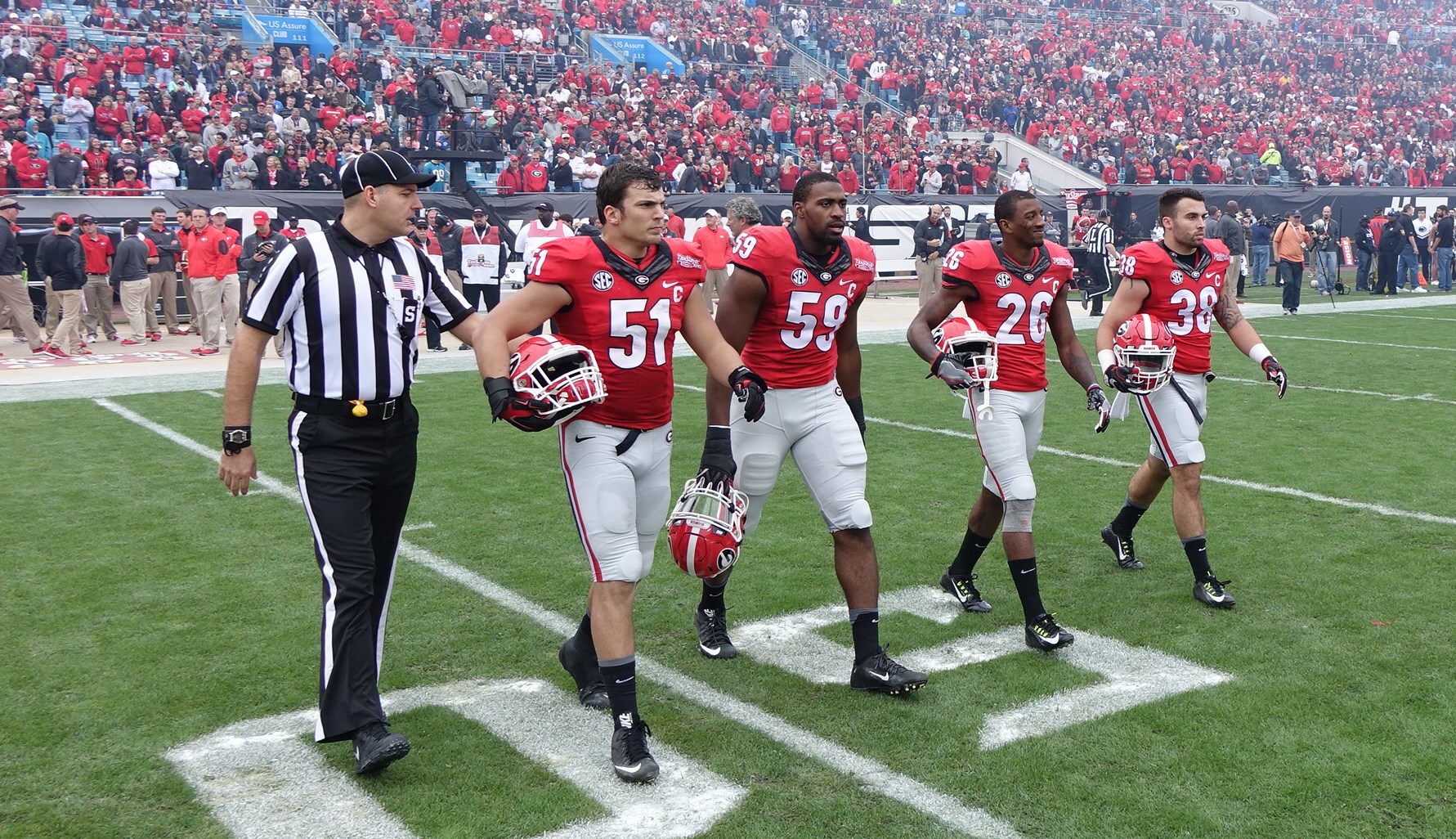TaxSlayer Bowl  opening ceremonies and coin toss 02-JAN-2016 (Left to right) No.51 Jake Ganus, No. 59 Jordan Jenkins, No.26 Malcolm Mitchell, and No.38 Ryne Rankin (Photo by Greg Poole)