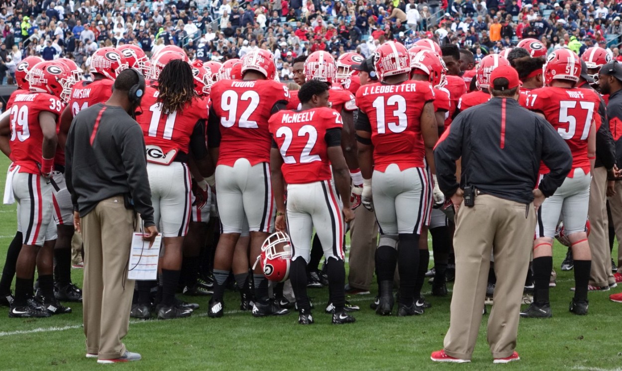 Georgia huddles up - 1st half TaxSlayer Bowl 02-JAN-2016 (Photo by Greg Poole)