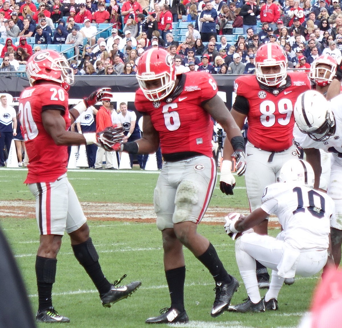 No.20 Quincey Mauger and No.6 LB Natrez Patrick after a big defensive play - 2nd half TaxSlayer Bowl 02-JAN-2016 (Photo by Greg Poole)