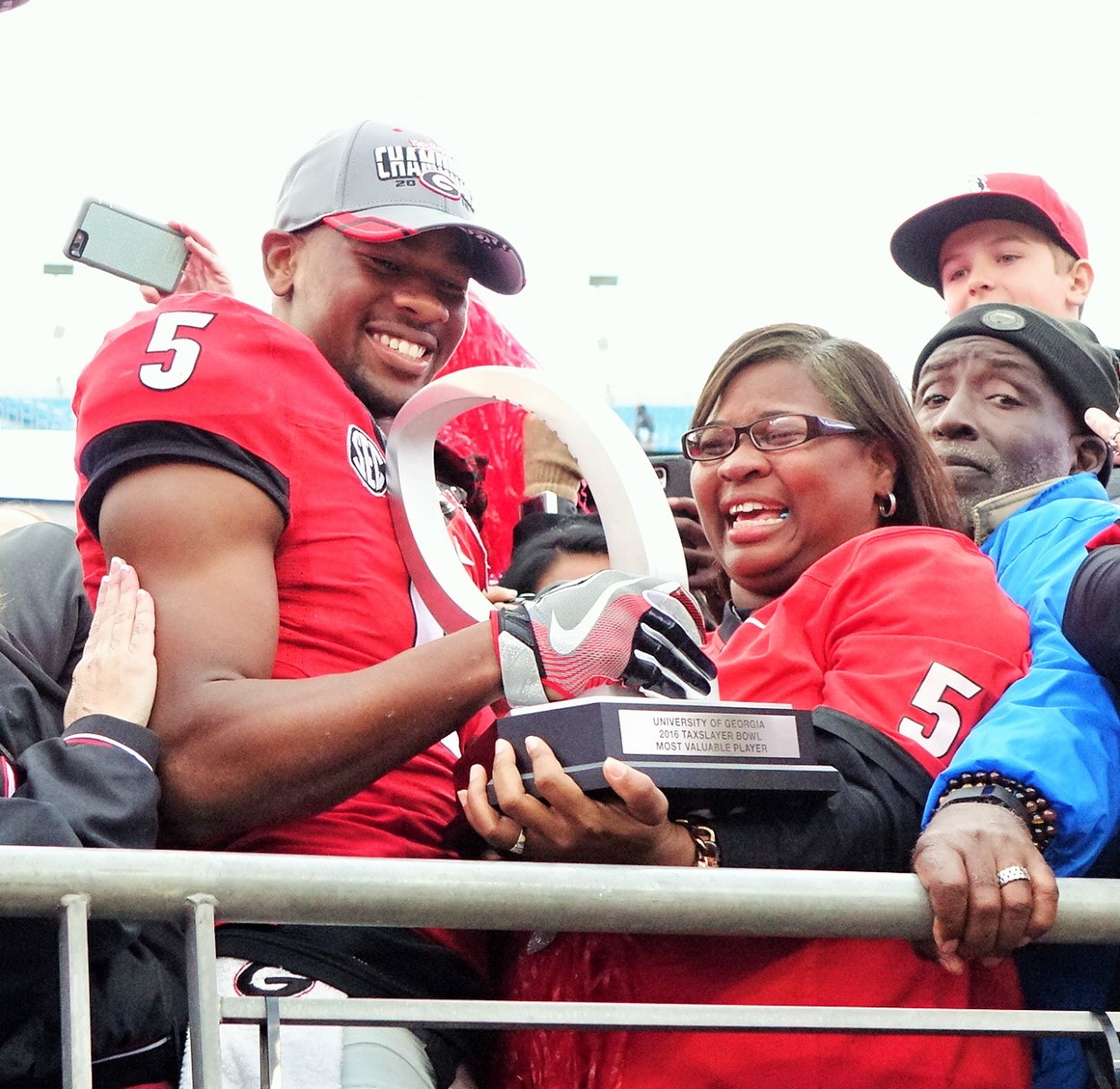 Terry and Mrs. Godwin with MVPs trophy - TaxSlayer Bowl post-game 02-JAN-2016