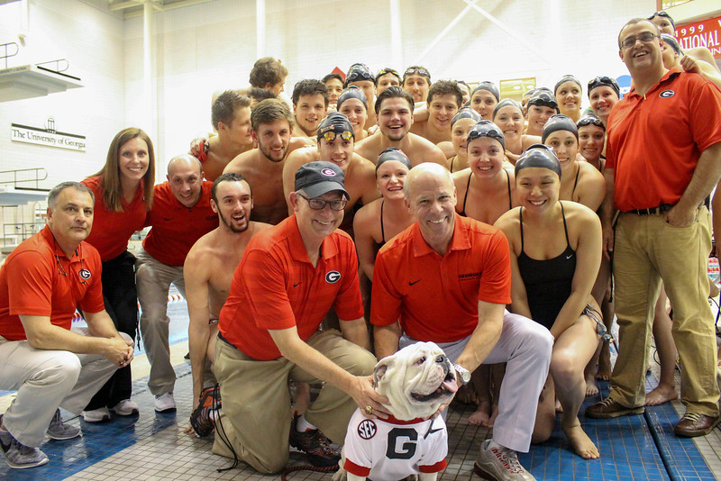 The Georgia swim team and staff pose for a photo with Uga after their 100th consecutive win after a meet between Georgia and Wisconsin on Saturday, Jan. 30, 2016, in Athens, Ga. (Photo by Emily Selby)