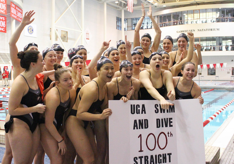 The women's swim team celebrates after their 100th consecutive home win after a meet between Georgia and Wisconsin on Saturday, Jan. 30, 2016, in Athens, Ga. (Photo by Emily Selby)