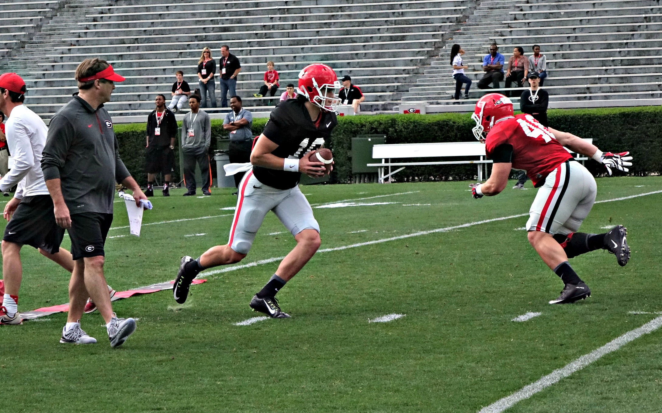 Jacob Eason hands off to Glenn Welch