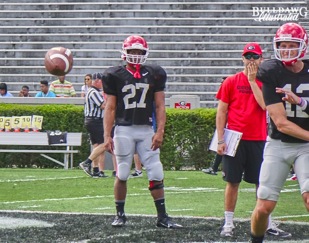 Brice Ramsey throws as Nick Chubb watches