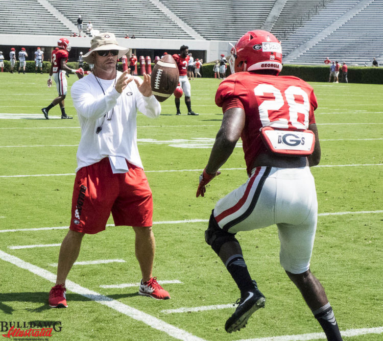 Shaquery Wilson works out with trainer on the sidelines