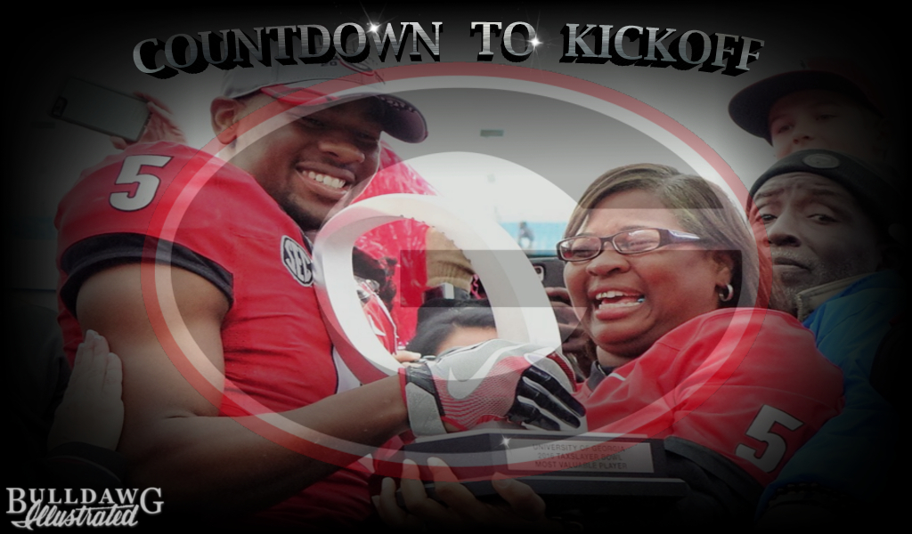 Terry and Mrs. Godwin with MVPs trophy - TaxSlayer Bowl post-game 02-JAN-2016, Photo: Greg Poole/Bulldawg Illustrated (edit by Bob Miller)