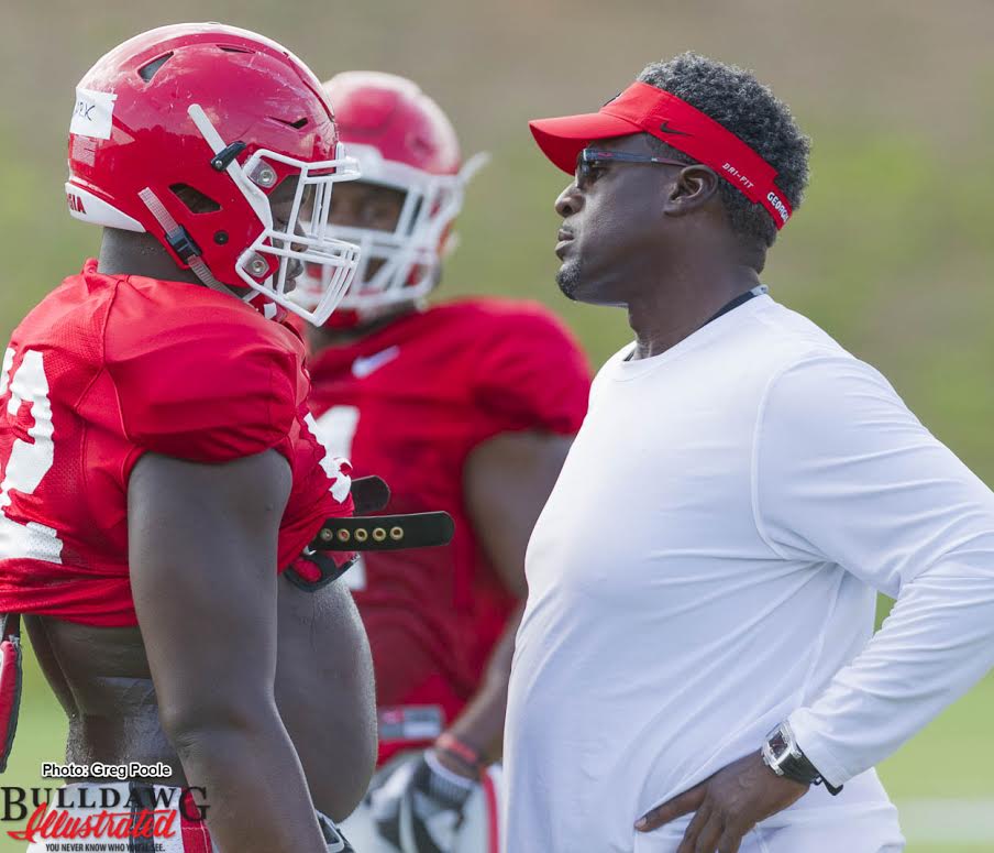 (L-R) Defensive lineman Tyler Clark (52) gets the stare from DL Coach Tracy Rocker