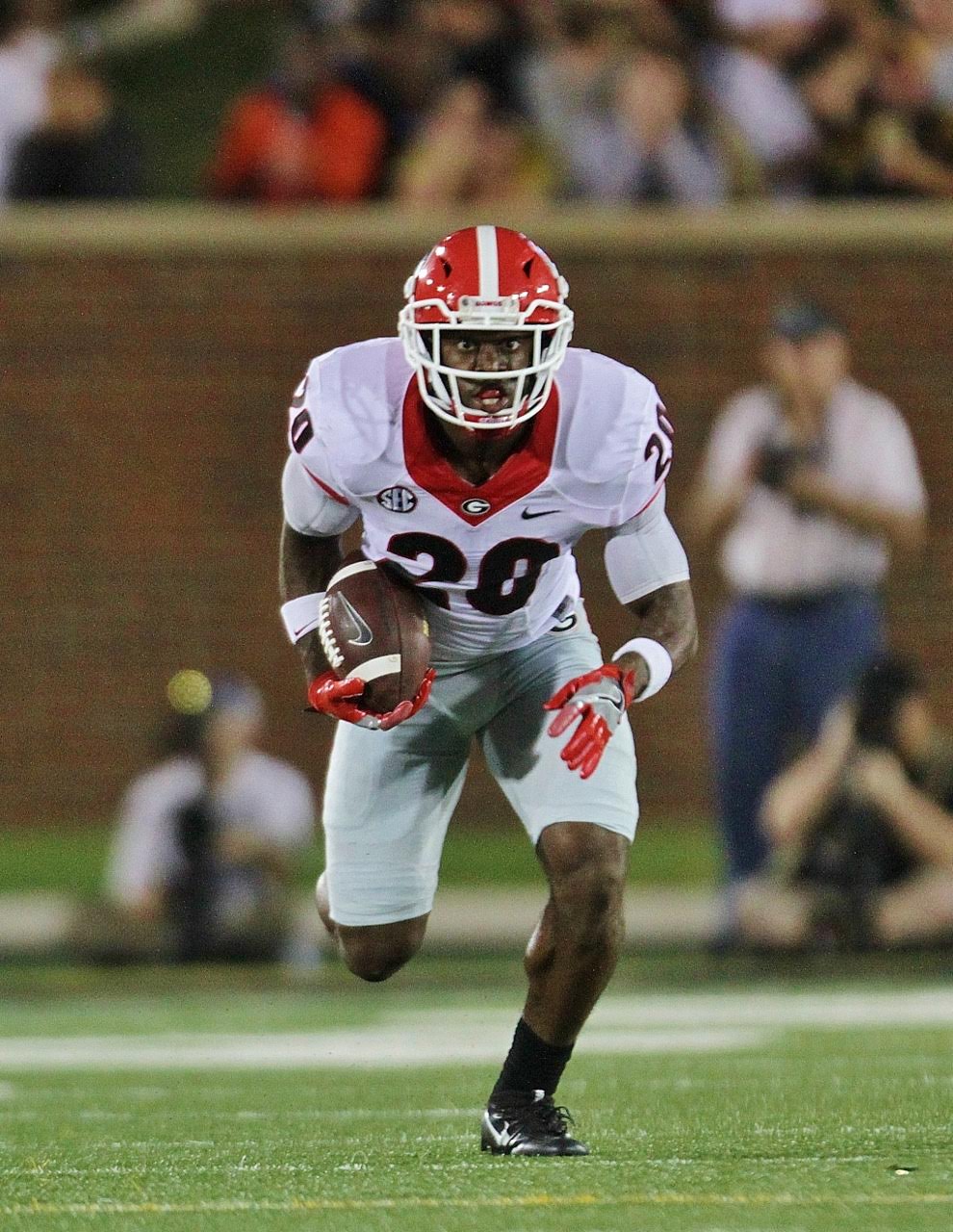 Quincy Mauger looks to return his first interception of the game for extra yards. (photo by Rob Saye)