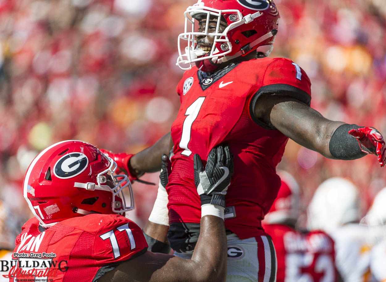 Isaiah Wynn (77) lifts Sony Michel (1) to celebrate a touchdown