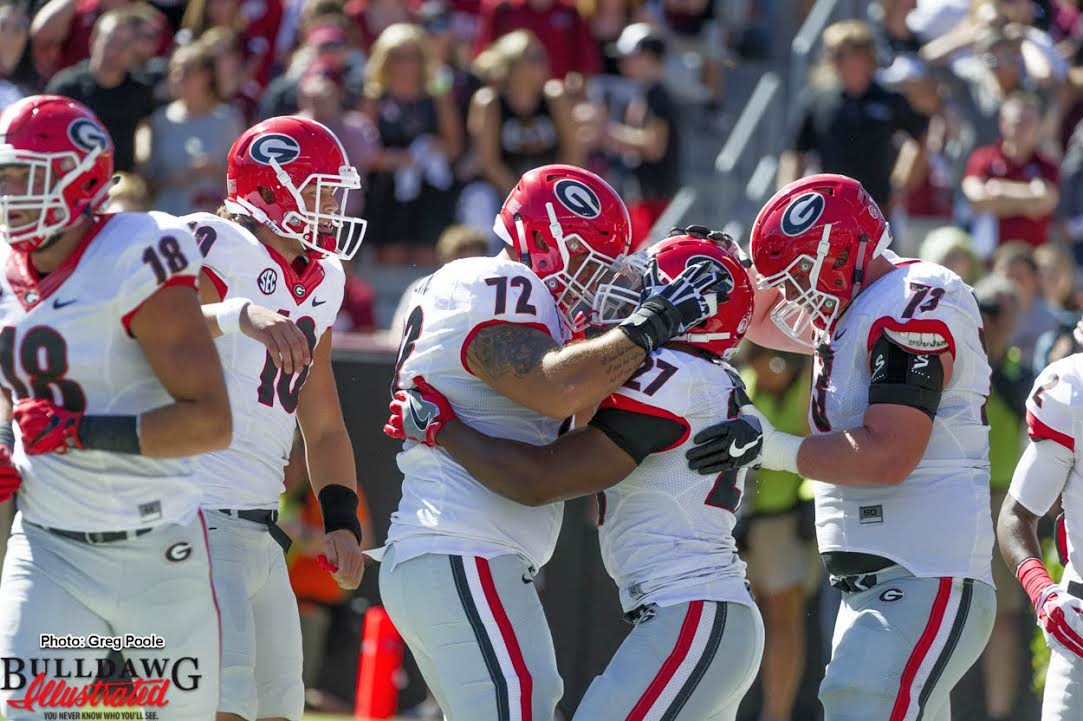 Offensive linemen celebrate with Nick Chubb (27) after one of his two TD runs against South Carolina (photo by Greg Poole)