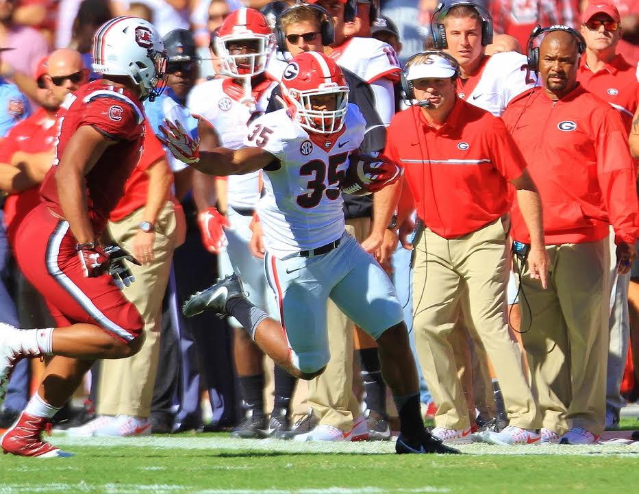 Brian Herrien (35) stiff arms a Carolina defender as Kirby looks on (photo by Rob Saye)