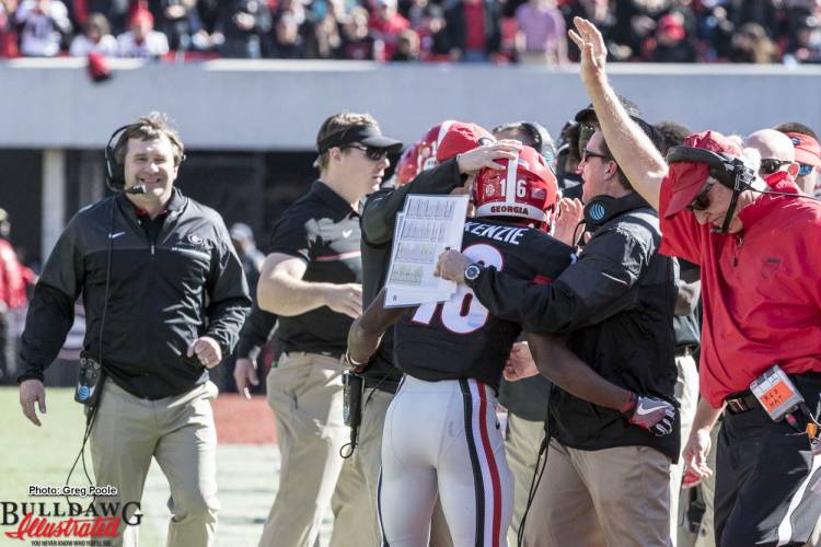 After Isaiah McKenzie (16) returns a punt for a TD, Head Coach Kirby Smart and the staff are all smiles.