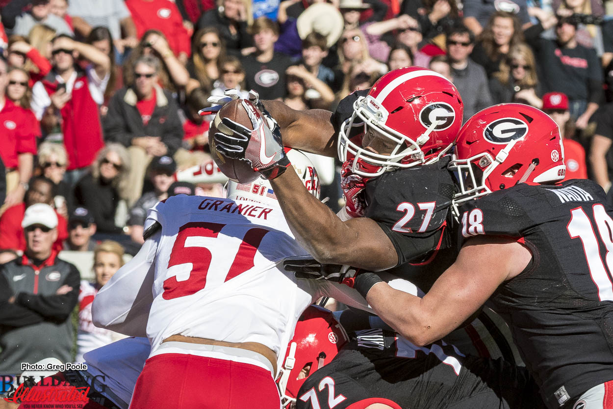 Nick Chubb (27) fights and extends the ball to break the plain of the goal line for a touchdown