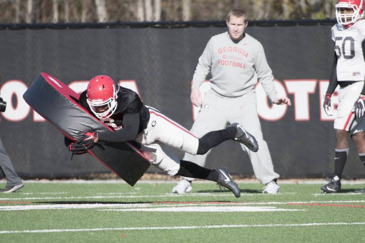 Natrez Patrick tackles tackling tube during a drill.