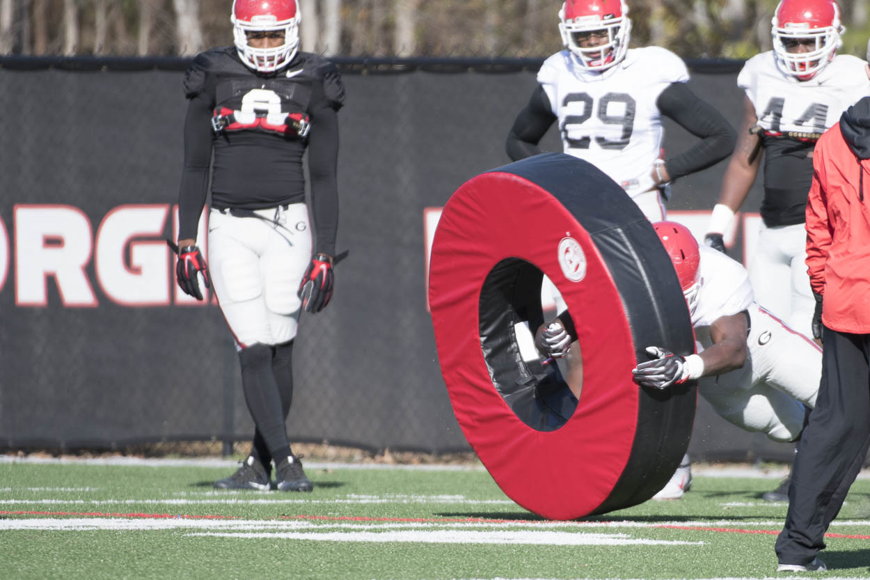 Players go through drill with tackling tube.
