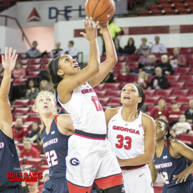 Haley Clark (12) shoots a layup as Mackenzie Engram (33) watches closely in case she needs to rebound.