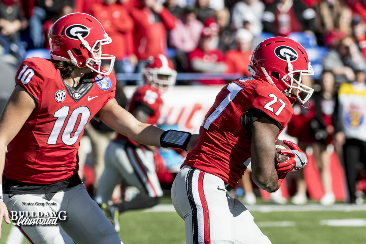 Jacob Eason (10) hands the ball off to Nick Chubb (27) during the Liberty Bowl.