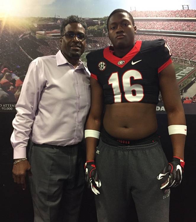 Brandon Henderson (right) with Georgia Defensive Line Coach Tracy Rocker (left) (photo from Brandon Henderson - Twitter)