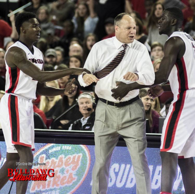 Mark Fox being held back by Derek Ogbeide(34) and Jordan Harris (2) is ejected from the Alabama game.