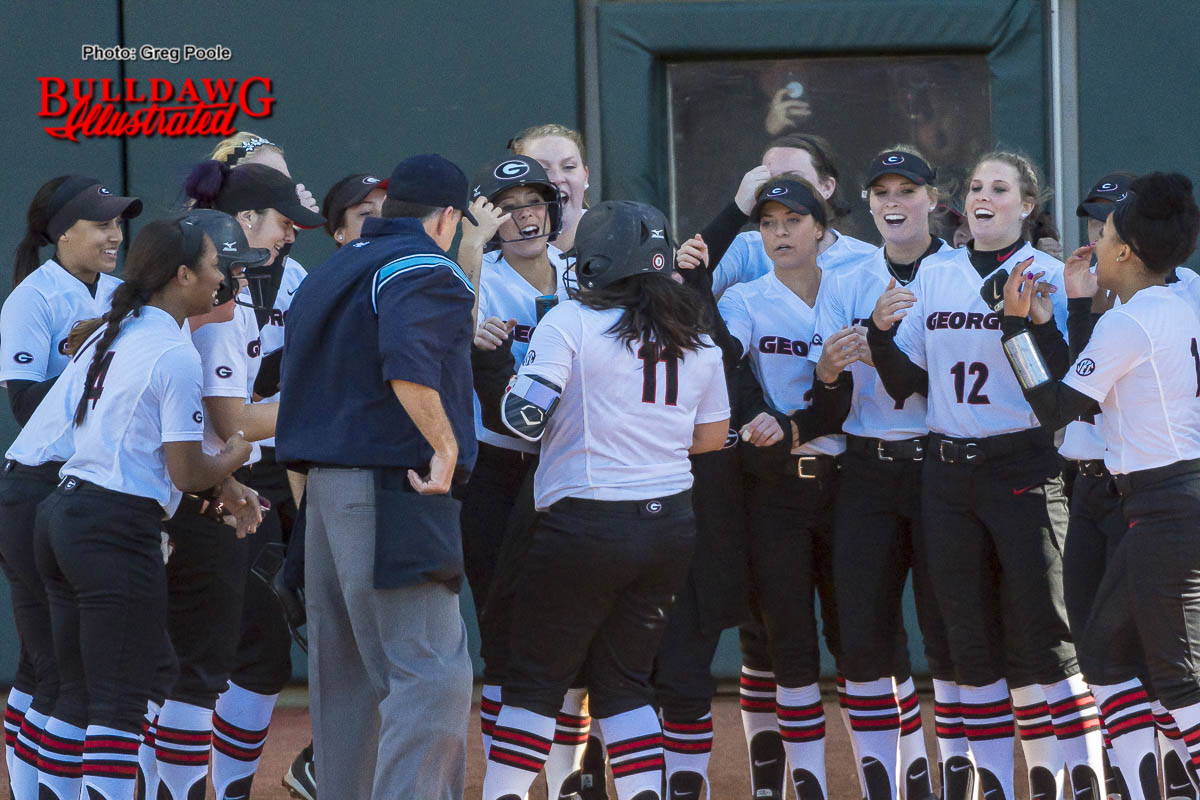 Mahlena O'Neal greeted by her teammates at home plate after her home run