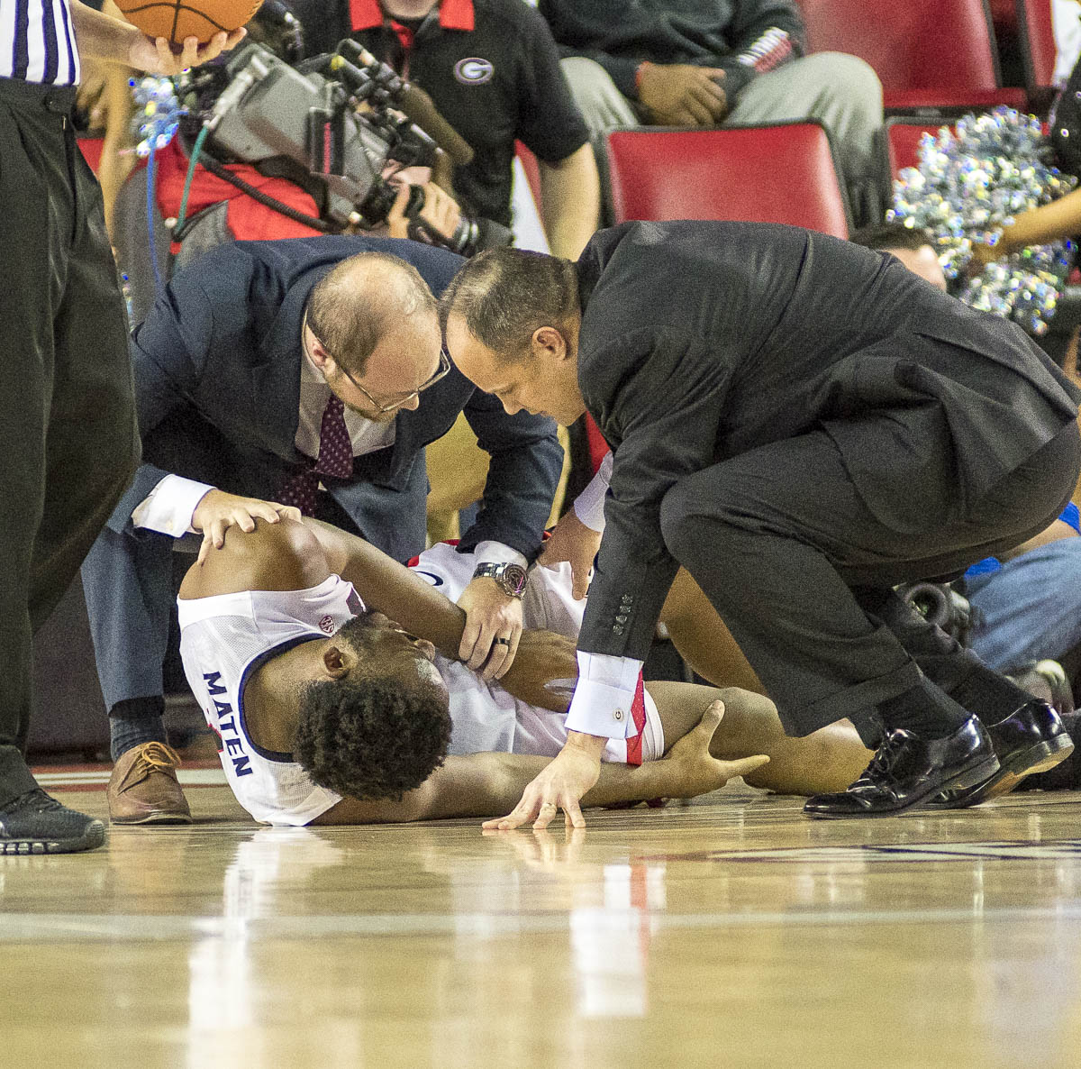 Coach Mark Fox and staff console Yante Maten (1) after he goes down with a leg injury early in the game versus Kentucky