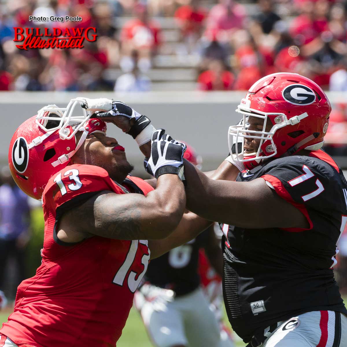 Isaiah Wynn (77) assists Jonathan Ledbetter (13) with removal of his helmet – G-Day 2017