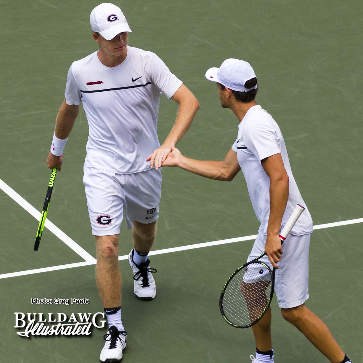 Walker Duncan (L) and his doubles partner Wayne Montgomery high five during the match vs. Florida A&M – May 12, 2017