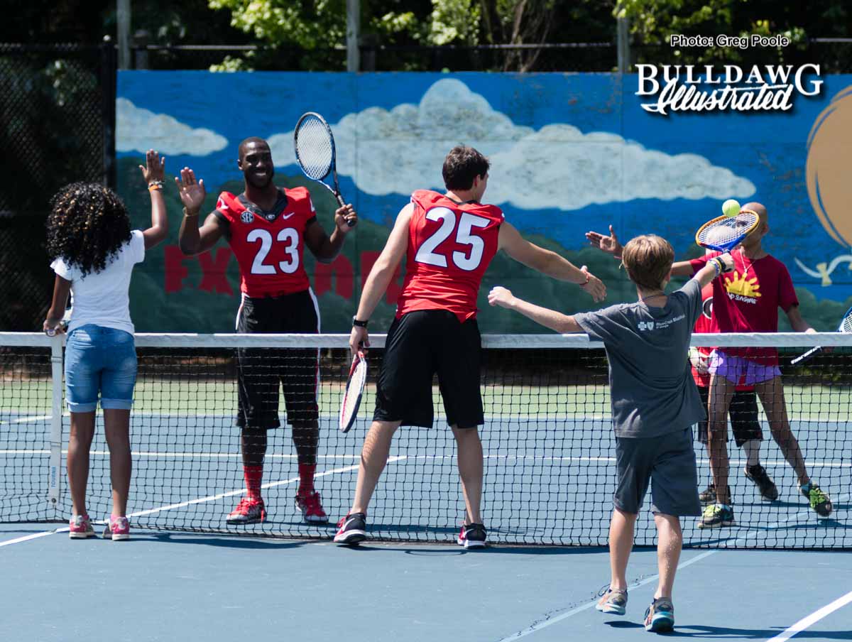 Shakenneth Williams (23) and Steven Van Tiflin (25) shake hands with other players on the tennis court after a game