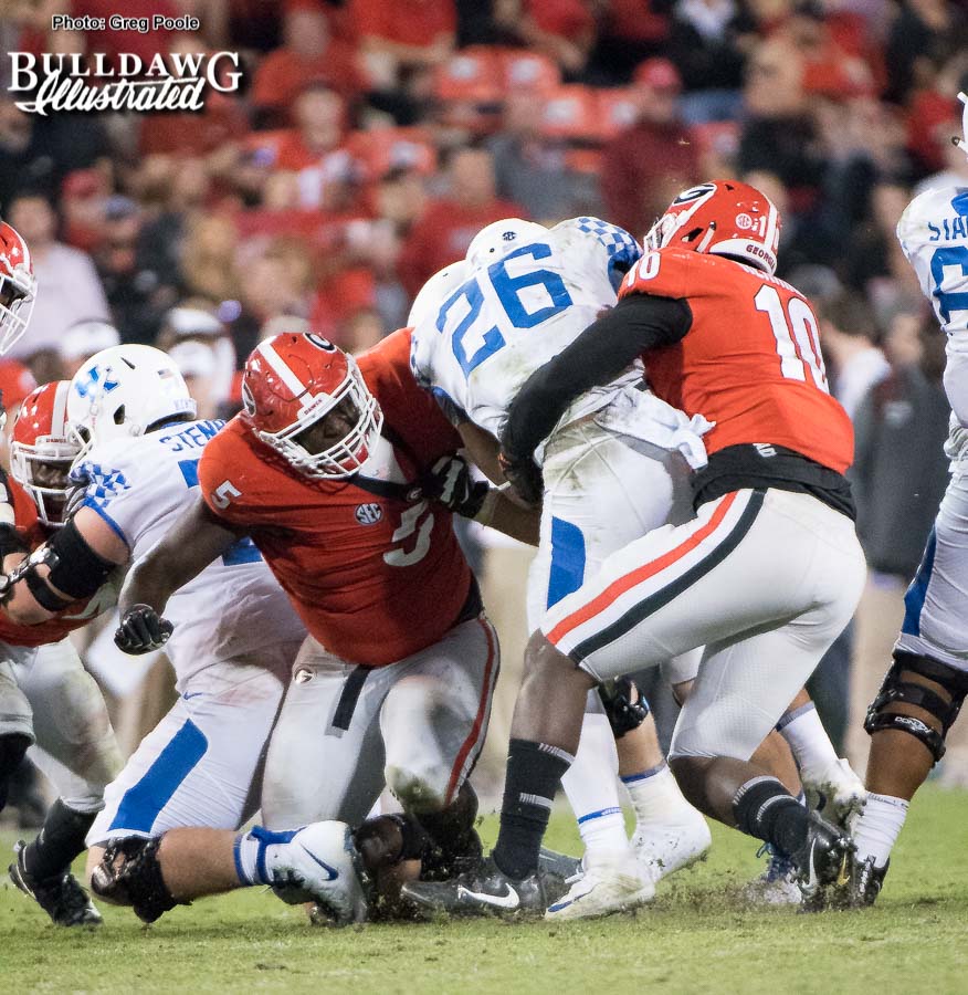Julian Rochester (5) and Malik Herring (10) tag team on the tackle of Cats' RB Benny Snell, Jr. (26) during the 2017 Kentucky game at Sanford Stadium.