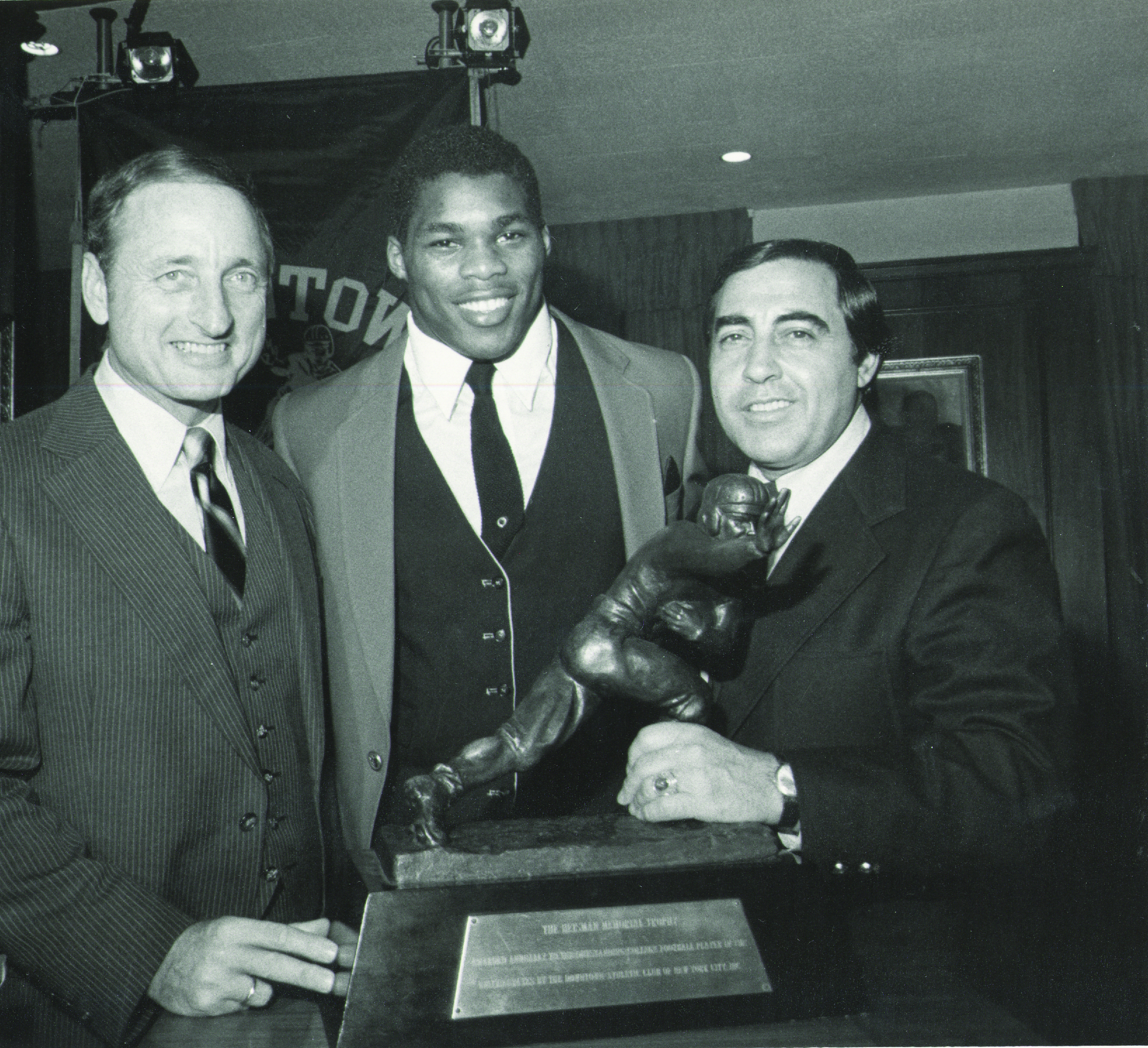 Vince Dooley with Herschel Walker poising with the Heisman Trophy, 1982.