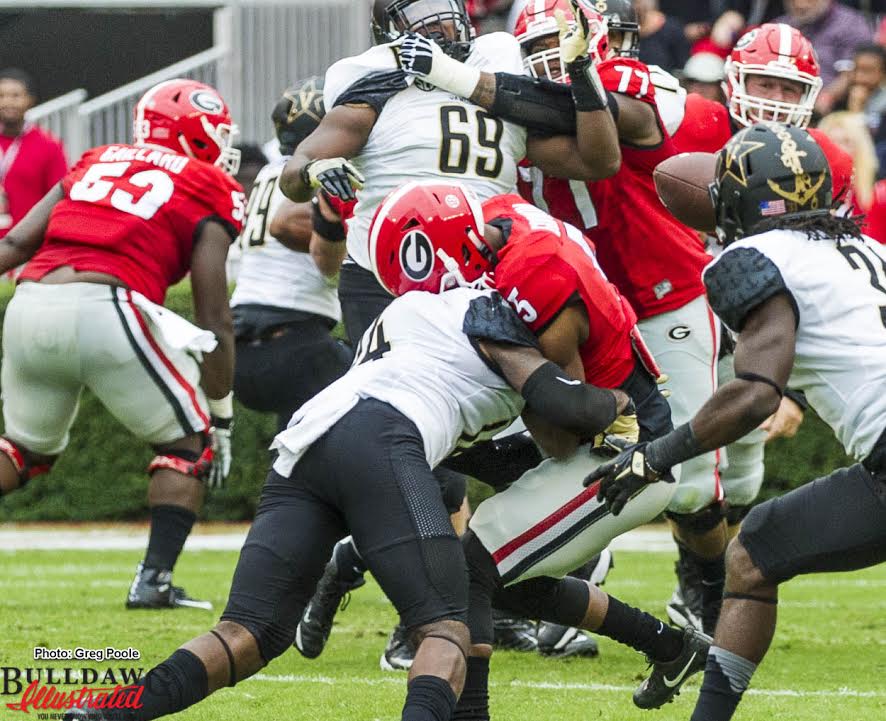 Terry Godwin (5) has his clock cleaned by Vandy Safety Ryan White (14)